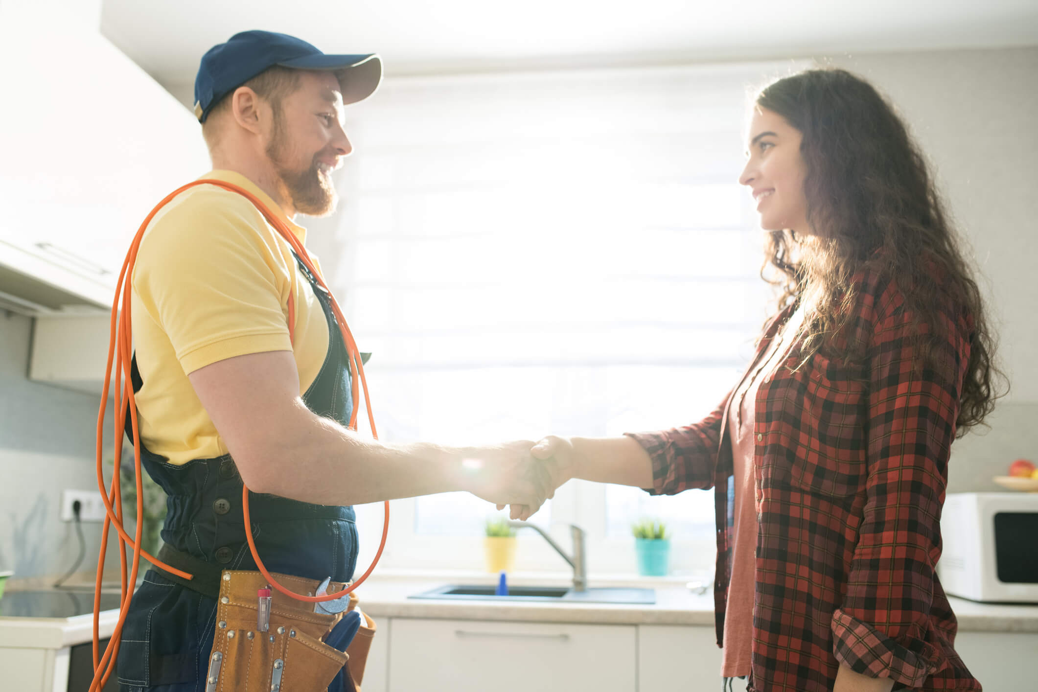 Homeowner and plumber handshake