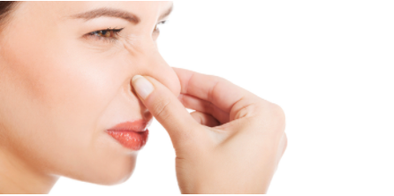 Woman holding nose because her furnace smells bad